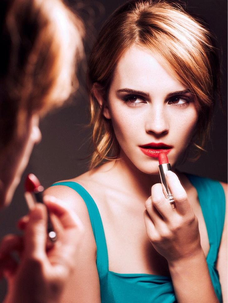Emma Watson putting on lipstick