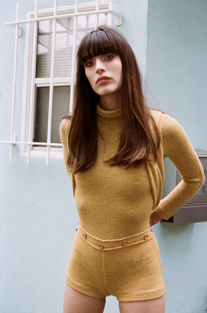 Louise Follain in yellow body suit